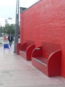 Mur et bancs rouges monochromes à la Place Rouge de Superkilen Copenhague, design urbain audacieux et identitaire.
